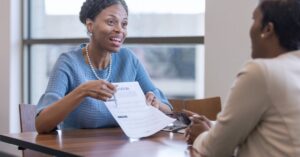 Business owner discussing a funding application with a financial advisor across a table.