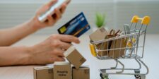 Google’s Universal Cart rolls out in the U.S. as AI shopping moves closer to checkout Hands holding a smartphone and credit card beside a miniature shopping cart filled with small parcels