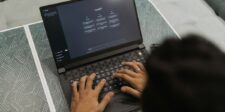Person typing on a laptop displaying ChatGPT