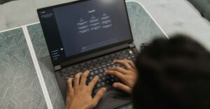 Person typing on a laptop displaying ChatGPT