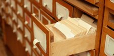 From footnotes to AI answers: how the internet decides what gets seen An open wooden library card catalog drawer packed with index cards