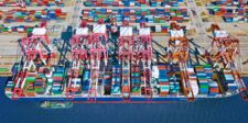 Los Angeles port hits cargo record as shippers reroute freight Aerial view of a busy container terminal with cargo ships, cranes and stacks of shipping containers.