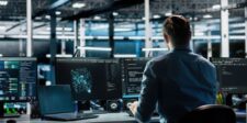 IT professional monitoring multiple computer screens, illustrating the Nextcloud app vulnerability exploited by hackers before an official security warning.
