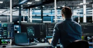 IT professional monitoring multiple computer screens, illustrating the Nextcloud app vulnerability exploited by hackers before an official security warning.