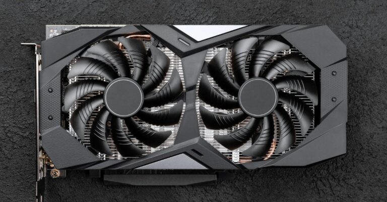 Graphics card with two cooling fans on a dark textured surface.