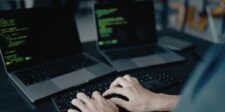 Railway says about 100,000 workspaces may have had secrets exposed Hands typing on a laptop keyboard with lines of code on two laptop screens