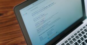 Laptop displaying Google search results on a wooden table