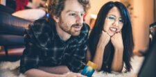 Couple shopping online during the holidays with a credit card, illustrating AI-assisted shopping and purchase decisions.