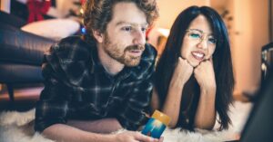 Couple shopping online during the holidays with a credit card, illustrating AI-assisted shopping and purchase decisions.