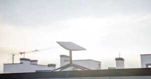 Starlink satellite dish mounted on a residential rooftop under a cloudy sky