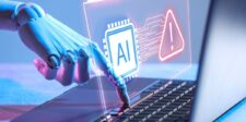 The web’s next AI fight is over who gets through the door Robotic hand reaching toward a laptop keyboard beneath a holographic AI chip and warning sign