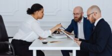 What is seller financing? A practical guide for buyers and sellers Business buyer, seller, and advisor reviewing financing documents during a business acquisition discussion.