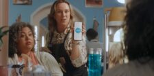 Hair stylist showing the Xero logo on a smartphone in an official Xero small-business accounting video.